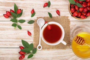 çay rose hips ve ballı Beyaz ahşap zemin üzerinde. Üstten Görünüm