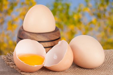 Bahçe arka plan bulanık bir tahta üzerinde ahşap bir kasede yumurta