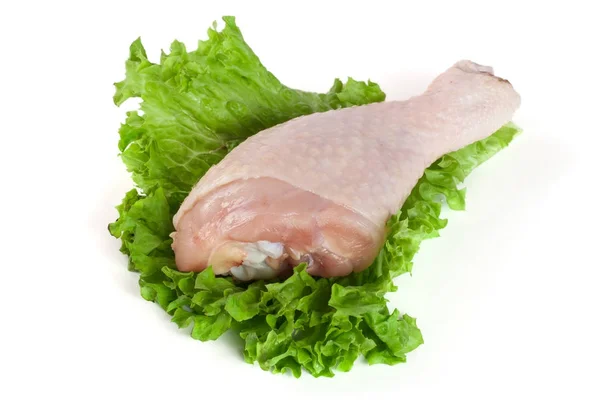 Raw chicken drumstick with lettuce leaf isolated on white background Stock Image