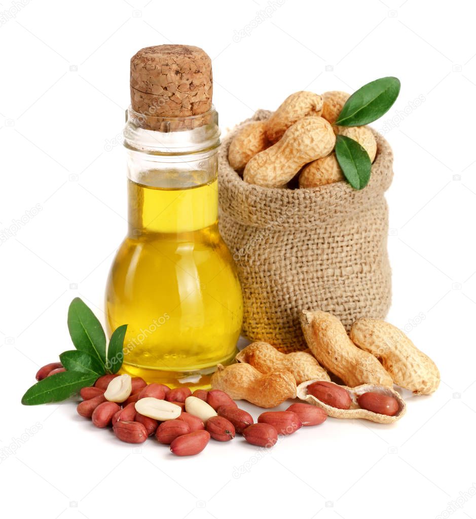 peanut oil in a glass bottle with peanuts in bag