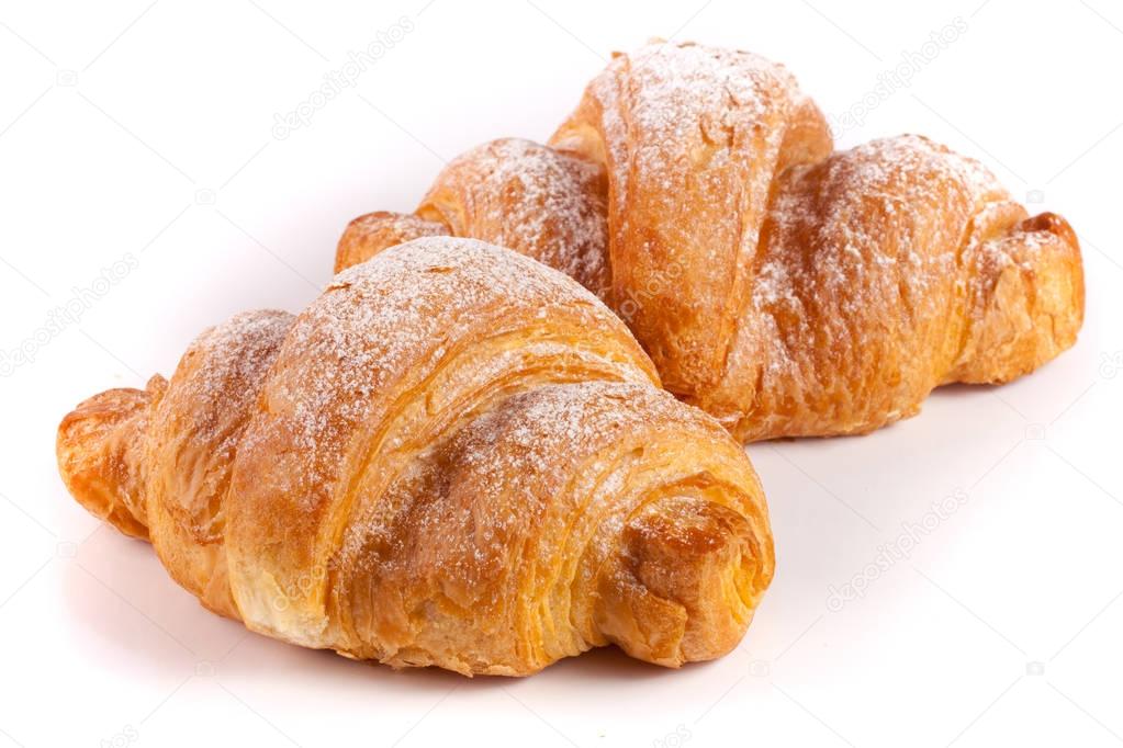two croissant sprinkled with powdered sugar isolated on a white background closeup