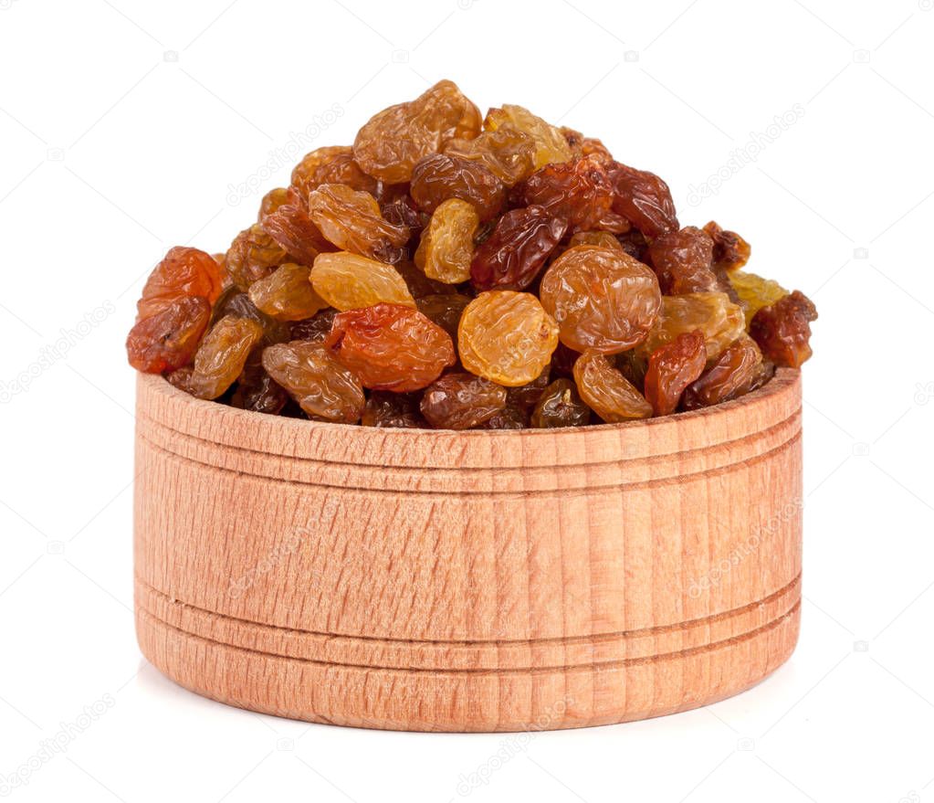 raisins in a wooden bowl isolated on white background