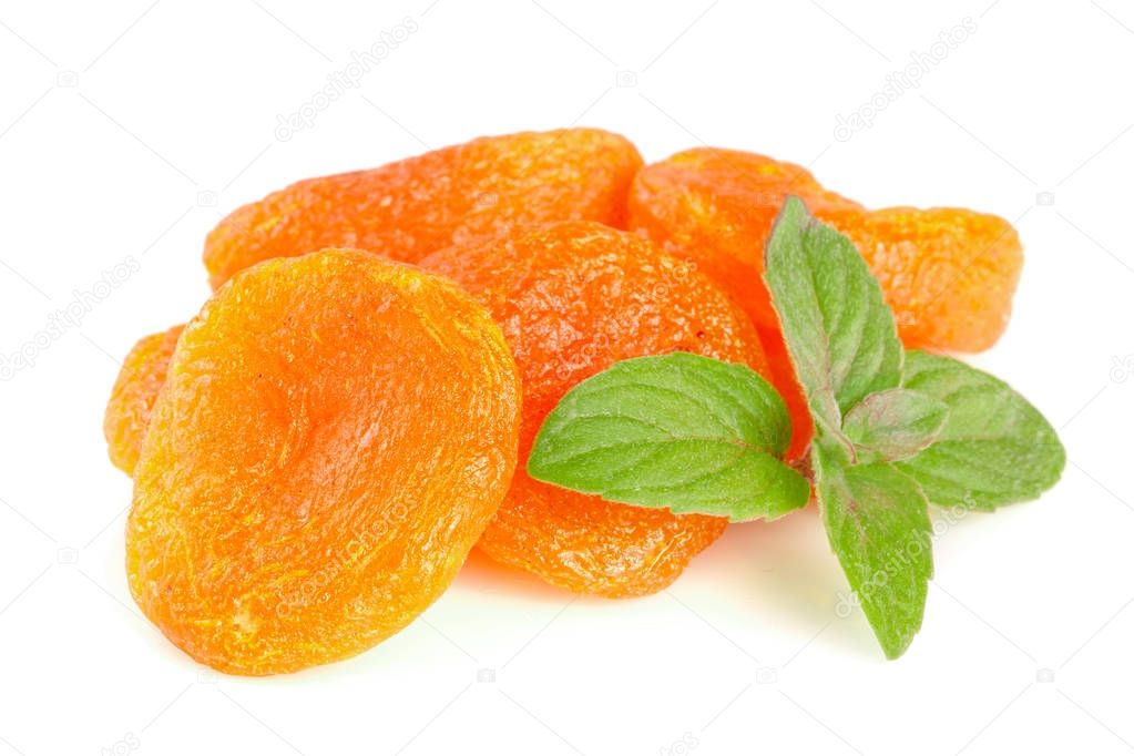 Dried apricots with mint leaves isolated on white background