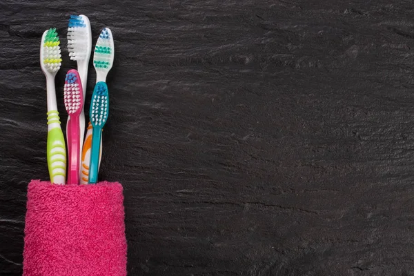 Toothbrushes on the black stone background with copy space for your text. Top view — Stock Photo, Image