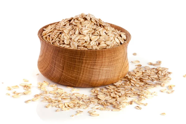 Oat flakes in a wooden bowl isolated on white background — Stock Photo, Image