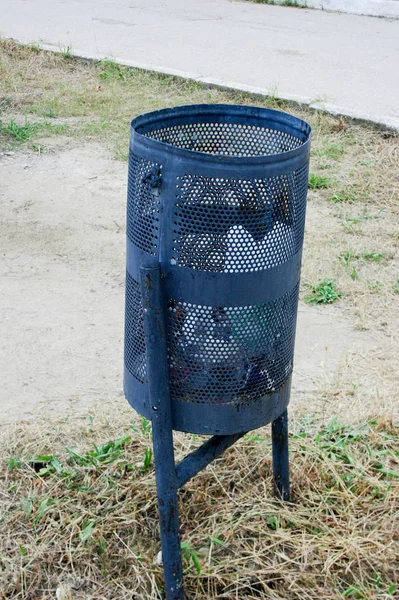 Small black metal garbage container or urn on the street — Stock Photo, Image