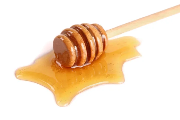 Honey stick s tekoucí zlato izolované na bílém pozadí — Stock fotografie