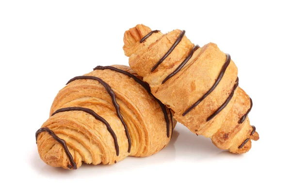 Croissant decorato con salsa al cioccolato isolata su sfondo bianco, vista dall'alto — Foto Stock