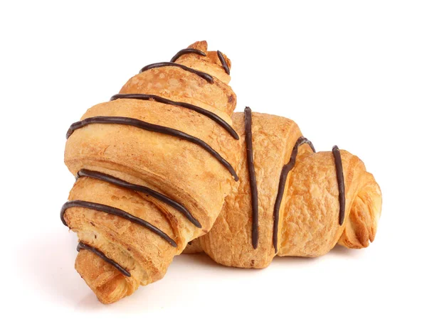 Croissant versierd met chocoladesaus geïsoleerd op een witte achtergrond, bovenaanzicht — Stockfoto