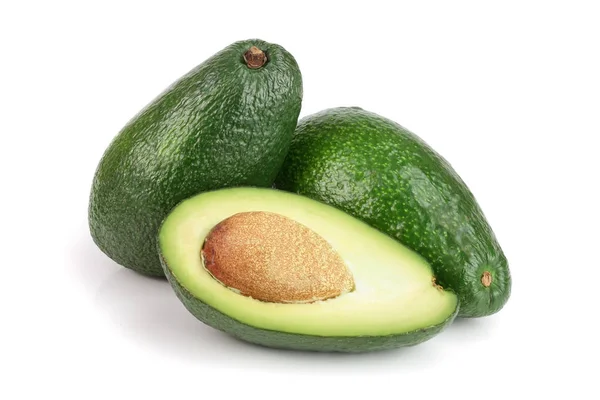 Aguacate entero y medio aislado sobre fondo blanco de cerca. Vista superior — Foto de Stock