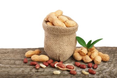 Fıstık çanta eski ahşap arka plan üzerinde yaprak ile