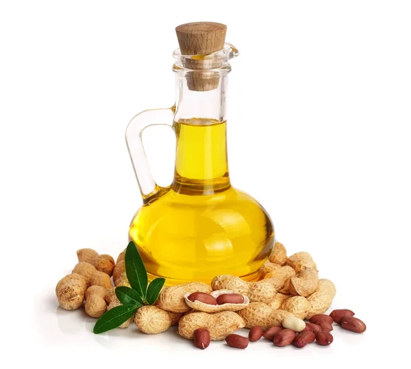 Arašídový olej ve skleněné láhvi s arašídy — Stock fotografie