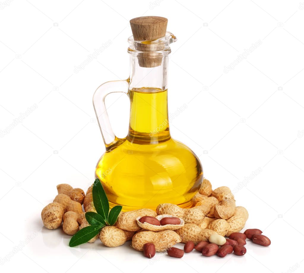 peanut oil in a glass bottle with peanuts