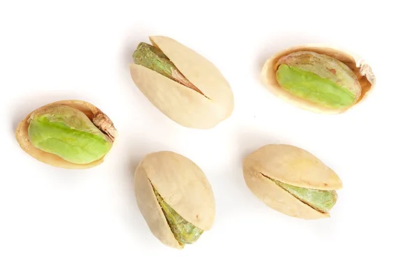 Pistacchi isolati su sfondo bianco, vista dall'alto. Posa piatta — Foto Stock