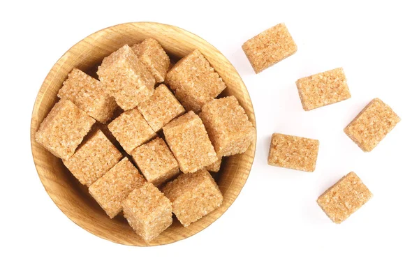 Brown sugar cubes in a wooden bowl isolated on white background. Top view. Flat lay — Stock Photo, Image