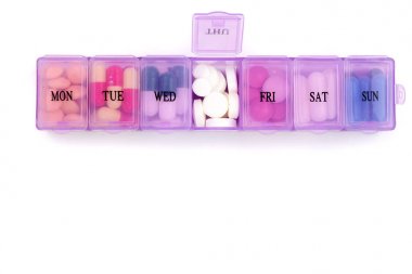 Daily pill box with medical pills isolated on white background with copy space for your text. Top view. Flat lay clipart