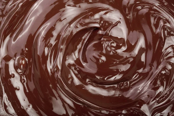 Remolino de chocolate derretido como primer plano de fondo —  Fotos de Stock