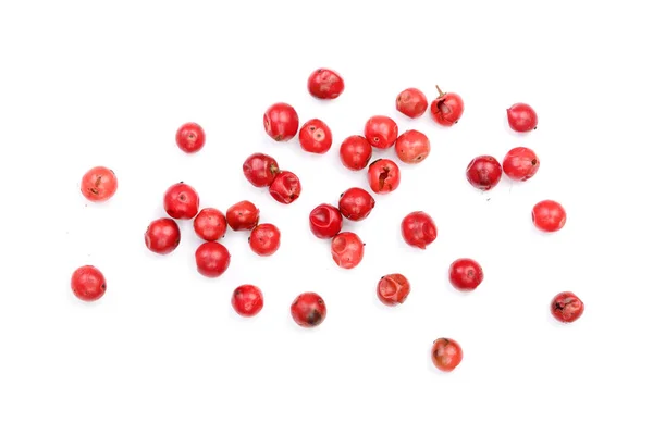 Semillas de granos de pimienta rosa aisladas sobre fondo blanco. Vista superior. Puesta plana — Foto de Stock