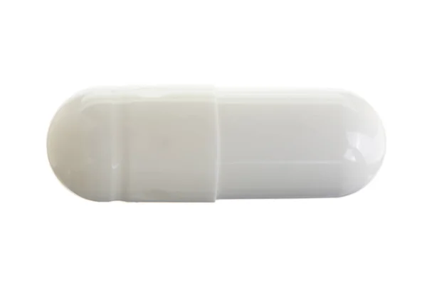 Cápsula de píldora blanca aislada sobre fondo blanco macro. Vista superior — Foto de Stock