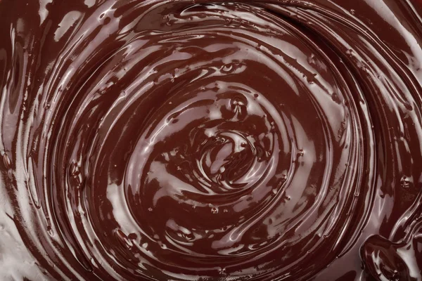 Розплавлений шоколадний вихор як фон крупним планом — стокове фото