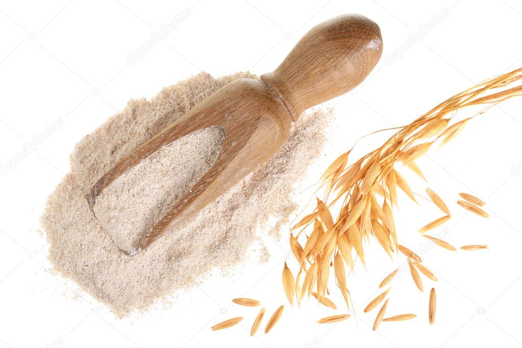 oat spike with flour in wooden scoop isolated on white background. Top view. Flat lay