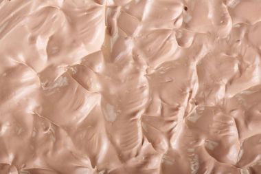 Arka plan olarak bej sıvı temel makyaj. Üstten Görünüm. Düz yatıyordu desen