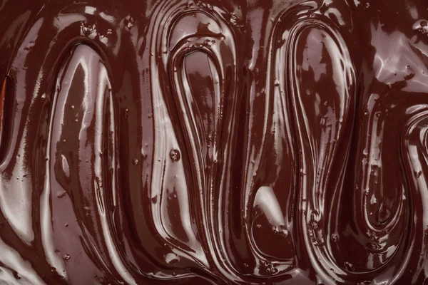 Schmelzschokoladenwirbel als Hintergrund-Nahaufnahme — Stockfoto