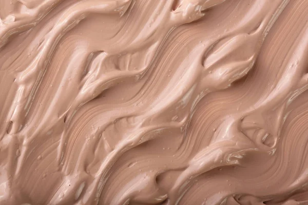 Beige liquid foundation makeup as a background. Top view. Flat lay pattern — Stock Photo, Image