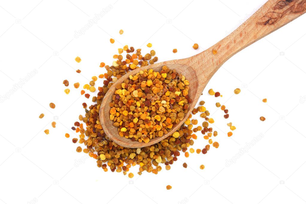 fresh bee pollen in wooden spoon isolated on white background. Top view. Flat lay