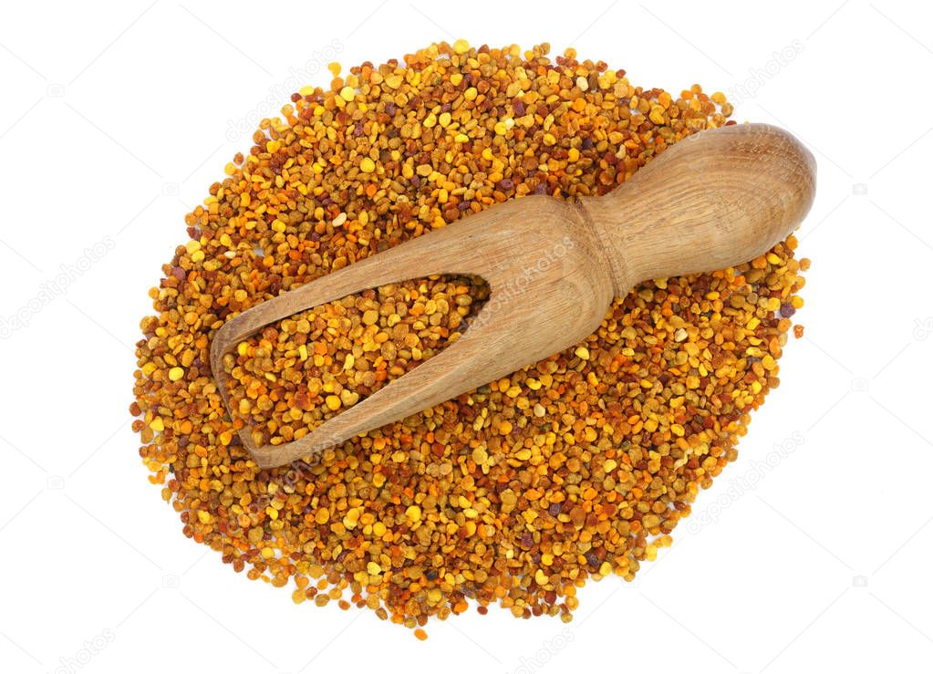 fresh bee pollen in wooden scoop isolated on white background. Top view. Flat lay