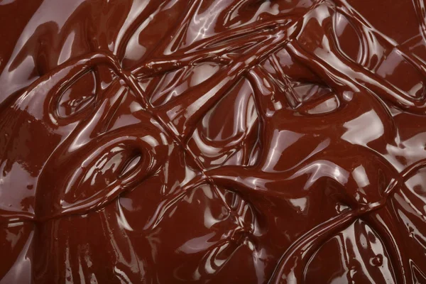 Melted chocolate swirl as a background closeup — Stock Photo, Image