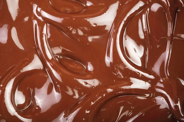 Melted chocolate swirl as a background closeup — Stock Photo, Image