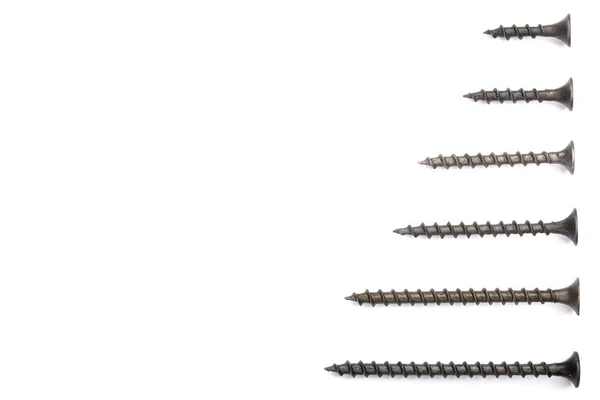 Black screws isolated on white background with copy space for your text. Top view. — Stock Photo, Image