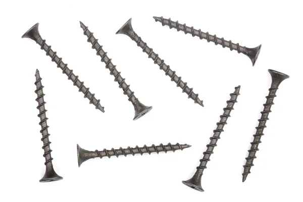 Black screws isolated on white background closeup. Top view. — Stock Photo, Image