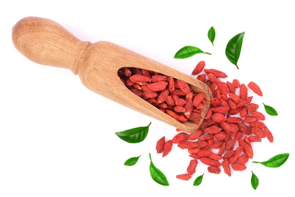 Dried goji berries in wooden scoop decorated with green leaves Isolated on white background — Stock Photo, Image