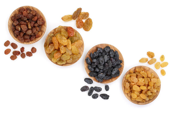 Collection of raisins in wooden bowl isolated on a white background with copy space for your text. Top view. Flat lay