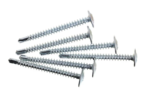 Metal screws isolated on white background closeup. Top view — Stock Photo, Image