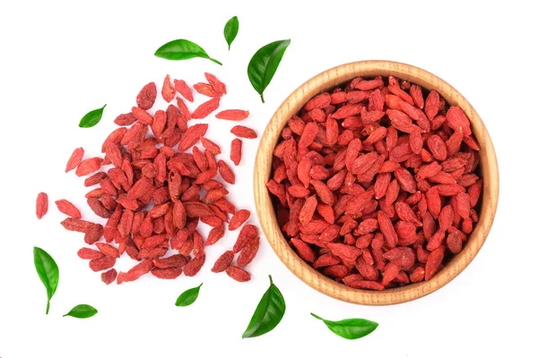 Dried goji berries in wooden bowl decorated with green leaves Isolated on white background — Stock Photo, Image