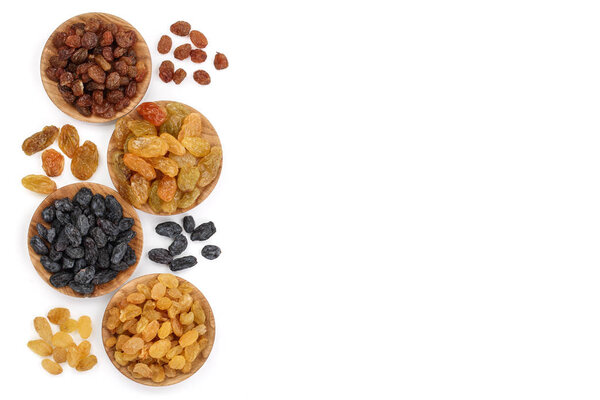 Collection of raisins in wooden bowl isolated on a white background with copy space for your text. Top view. Flat lay