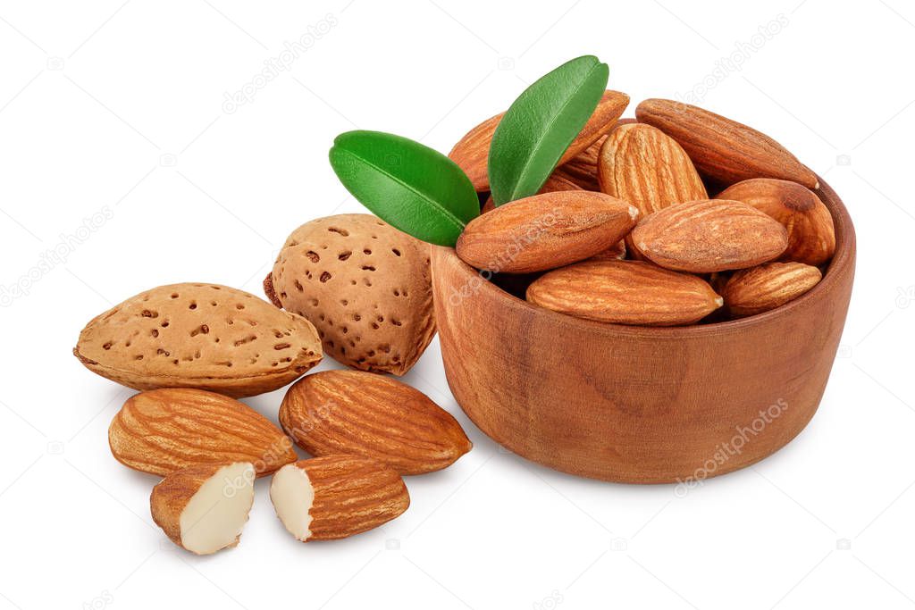 Almonds nuts with leaves in wooden bowl isolated on white background with clipping path and full depth of field.