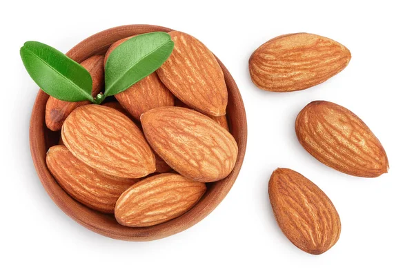 Almonds nuts with leaves in wooden bowl isolated on white background with clipping path and full depth of field. Top view. Flat lay. — Stock Photo, Image