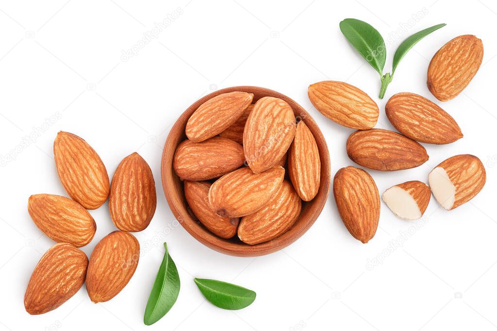 Almonds nuts with leaves in wooden bowl isolated on white background with clipping path and full depth of field. Top view. Flat lay.