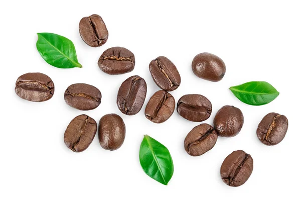 Tas de grains de café torréfiés avec des feuilles isolées sur fond blanc. Vue de dessus. Pose plate. — Photo