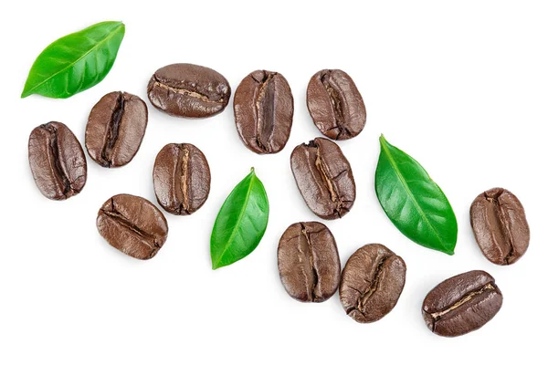 Heap of roasted coffee beans with leaves isolated on white background . Top view. Flat lay. — Stock Photo, Image