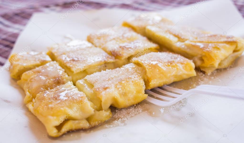 Dessert style of fried Roti with banana cooking on the street in Bangkok, Thailand