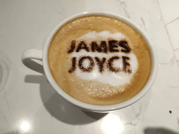 a cup of cappuccino coffee with a white background