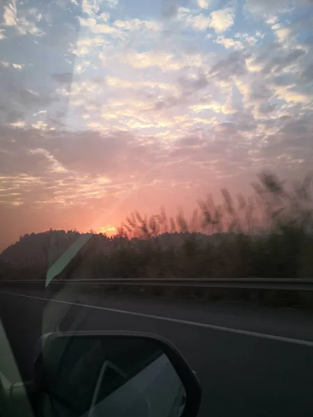 stock image sunset over the road in the mountains