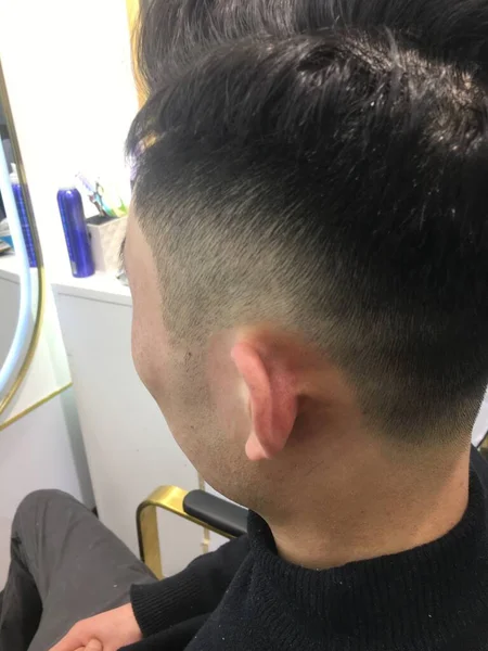 man with beard and hair clipper in the salon