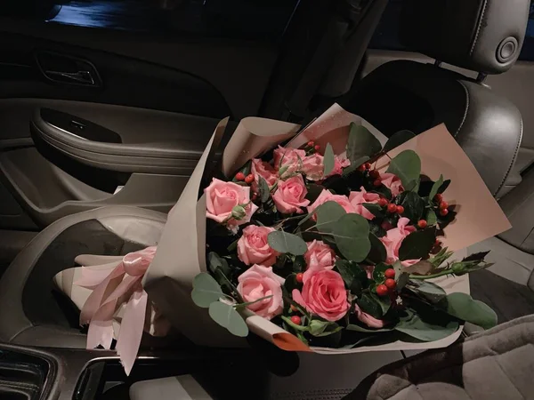 a bouquet of roses in a car