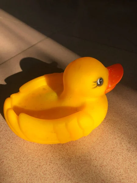 yellow duck in a glass on a white background